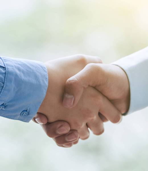 Business partners shaking hands to confirm the deal